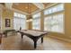 A billiards room with a pool table and a view from the large bright windows at 8168 Boat Hook Loop # 707, Windermere, FL 34786