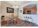 Dining area features wood flooring, pendant lighting and decorative archway to adjacent kitchen at 8168 Boat Hook Loop # 707, Windermere, FL 34786