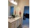 This bathroom features a double vanity and a view into a living room at 8237 Serenity Spring Dr # 2605, Windermere, FL 34786