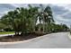 Community entrance featuring lush tropical landscaping, palms, and gated access at 8237 Serenity Spring Dr # 2605, Windermere, FL 34786