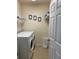 This laundry room features a washer, dryer, and a rack for hanging clothes at 8237 Serenity Spring Dr # 2605, Windermere, FL 34786