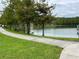 Scenic walking path along the pond with lush greenery at 8237 Serenity Spring Dr # 2605, Windermere, FL 34786