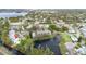 Stunning aerial view of a lakeside community, showcasing a pond with fountain, lush landscaping, and mature trees at 832 Westshore Ct, Casselberry, FL 32707