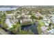 Beautiful aerial view of a lakeside community with lush landscaping, a pond with fountain, and mature trees at 832 Westshore Ct, Casselberry, FL 32707