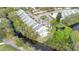 Scenic aerial view of townhomes nestled along a waterway and surrounded by lush landscaping and mature trees at 832 Westshore Ct, Casselberry, FL 32707