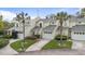 Exterior of townhomes showcases two-story design, palm trees, and attached garages at 832 Westshore Ct, Casselberry, FL 32707