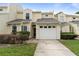 Charming townhouse featuring a one-car garage, landscaped front yard, and a welcoming entryway at 832 Westshore Ct, Casselberry, FL 32707