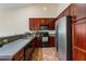 Close-up of the kitchen showcasing dark cabinets, ample counter space, and modern appliances at 832 Westshore Ct, Casselberry, FL 32707