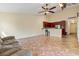 Open living area with tile floors, bar seating, and seamless flow to the kitchen at 832 Westshore Ct, Casselberry, FL 32707