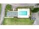 Overhead shot of a pool surrounded by lush landscaping, palm trees, lounge chairs, and parking space at 832 Westshore Ct, Casselberry, FL 32707