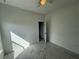 This bedroom features light gray tile flooring, neutral walls, and an open doorway at 1006 India St, Haines City, FL 33844