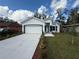 Beautiful single-story home boasting fresh landscaping and a concrete driveway at 1006 India St, Haines City, FL 33844