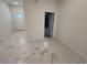 Hallway leads to the home's garage and a front door with sidelight at 1006 India St, Haines City, FL 33844