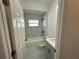 Bathroom featuring a tub and shower combo with a gray vanity and a toilet at 1012 India Ave, Haines City, FL 33844