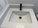 Bathroom vanity with white countertop, black faucet, and rectangular sink at 1012 India Ave, Haines City, FL 33844