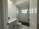 Clean bathroom with marble tile shower, gray vanity, and modern fixtures at 1012 India Ave, Haines City, FL 33844