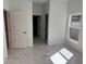 Bright bedroom featuring white walls, marble-patterned tile flooring, and a window at 1012 India Ave, Haines City, FL 33844