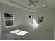 Well-lit bedroom featuring tile flooring, a modern ceiling fan and two windows at 1012 India Ave, Haines City, FL 33844