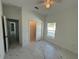 Bedroom with white walls, large window, and white marble-style flooring at 1012 India Ave, Haines City, FL 33844