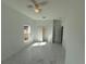 Bedroom with white walls, large window, ceiling fan, and white marble-style flooring at 1012 India Ave, Haines City, FL 33844