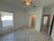 Bedroom with window and closet, featuring marble tile floors, and neutral color palette at 1012 India Ave, Haines City, FL 33844