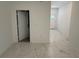 Bright entryway with white walls and modern white marble-style flooring at 1012 India Ave, Haines City, FL 33844