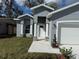 Beautiful single Gathering home featuring manicured lawn, fresh exterior paint, and charming front entrance columns at 1012 India Ave, Haines City, FL 33844