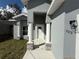 Inviting front entryway featuring stately columns with stone accents leading to a bright white front door at 1012 India Ave, Haines City, FL 33844