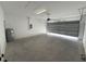 Bright, two-car garage featuring a sealed concrete floor, automatic door, and utility connections at 1012 India Ave, Haines City, FL 33844