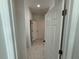 Hallway with open white doors and tile floors, leading to other rooms at 1012 India Ave, Haines City, FL 33844