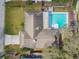 Aerial view of a single-Gathering home featuring a private pool, deck, and mature landscaping at 104 E Cottesmore Cir, Longwood, FL 32779