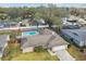 Aerial view of the property featuring a fenced pool and lush surrounding landscape at 104 E Cottesmore Cir, Longwood, FL 32779