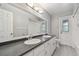 Bright bathroom with a double sink vanity, a large mirror, and white cabinets at 104 E Cottesmore Cir, Longwood, FL 32779