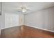 This bedroom features hardwood floors, neutral paint, a ceiling fan, and closet for ample storage at 104 E Cottesmore Cir, Longwood, FL 32779