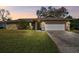 Charming single-story home featuring a stone facade and well-manicured lawn at 104 E Cottesmore Cir, Longwood, FL 32779