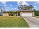 Charming single-story home featuring a stone facade and well-manicured lawn at 104 E Cottesmore Cir, Longwood, FL 32779