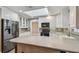 Well-lit kitchen featuring white cabinets, stainless steel appliances, and plenty of counter space at 104 E Cottesmore Cir, Longwood, FL 32779