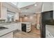 Bright kitchen featuring white cabinets, a skylight, and sleek appliances at 104 E Cottesmore Cir, Longwood, FL 32779