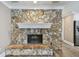 Close up of living room showing stone fireplace and luxury vinyl flooring at 104 E Cottesmore Cir, Longwood, FL 32779