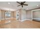 Spacious living room featuring wood floors, a ceiling fan, and natural light at 104 E Cottesmore Cir, Longwood, FL 32779