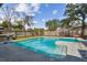 Inviting backyard pool surrounded by a concrete deck, wooden fence, and lush landscaping at 104 E Cottesmore Cir, Longwood, FL 32779