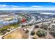 Aerial view of a neighborhood with lakes, green spaces, and residential homes at 1047 Bluegrass Dr, Groveland, FL 34736