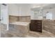 Bathroom with a soaking tub, dark wood vanity, and gray stone accents for a modern touch at 1047 Bluegrass Dr, Groveland, FL 34736