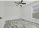 Bedroom with a ceiling fan and window, providing natural light and ample space at 1047 Bluegrass Dr, Groveland, FL 34736