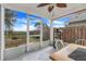 Relaxing screened porch with scenic backyard views and ceiling fan at 1047 Bluegrass Dr, Groveland, FL 34736