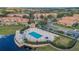 Aerial view of the community pool, clubhouse, and the surrounding townhome community at 10509 Belfry Cir, Orlando, FL 32832