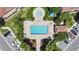 Aerial view of a pristine community pool and spa surrounded by lush landscaping at 10509 Belfry Cir, Orlando, FL 32832