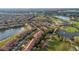 An aerial view showcases a townhome community with waterways, golf course, and clubhouse amenities at 10509 Belfry Cir, Orlando, FL 32832