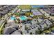 Aerial view featuring community amenities, including a pool, parking, and playground at 10509 Belfry Cir, Orlando, FL 32832