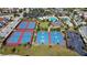 Aerial view of community tennis and basketball courts with clubhouse and pool at 10509 Belfry Cir, Orlando, FL 32832